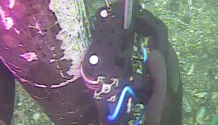 Diver conducting underwater weld inspection