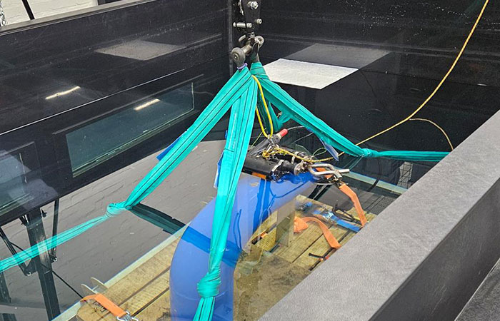 FAT setup featuring pipe elbow replicas in a water test tank